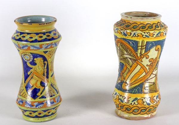 Lot of two Italian majolica albarelli, entirely decorated with musical instruments and a rampant lion