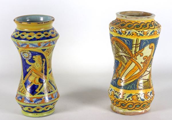 Lot of two Italian majolica albarelli, entirely decorated with musical instruments and a rampant lion