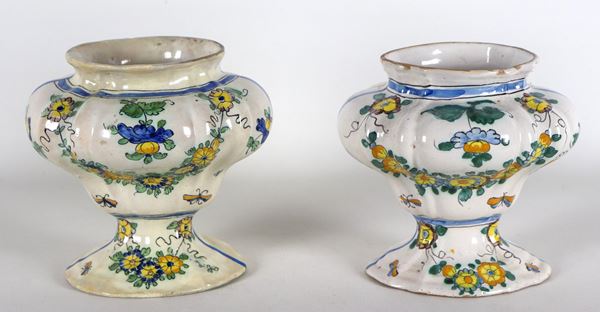 Pair of Italian majolica vases with polychrome decorations of floral garlands. One vase has several old restorations