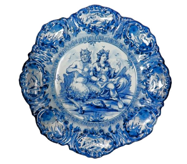 "Pan and the Nymph", Albisola majolica parade plate decorated in blue on a white background, 1930s. Part of the edge shows old restoration