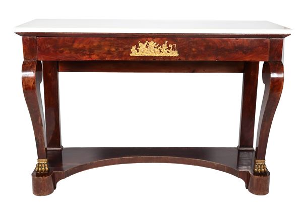Ancient Tuscan Empire console in mahogany and mahogany feather, with chiselled and embossed gilded bronze friezes, top in statuary white marble, a central drawer and curved legs ending in a lion's paw