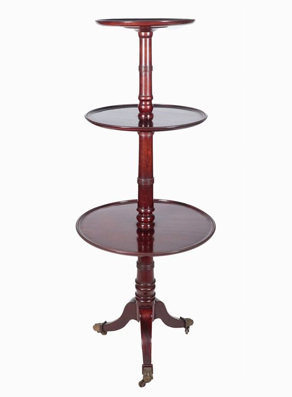 Antique English mahogany valet stand with three round shelves, supported by a turned central column, resting on three curved legs
