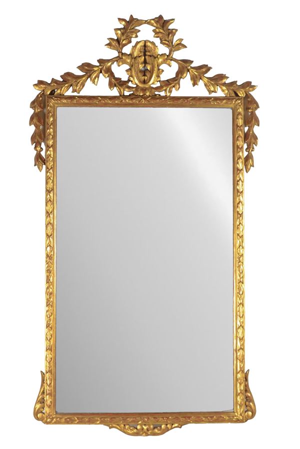 Mirror in gilded wood and carved with Louis XVI motifs