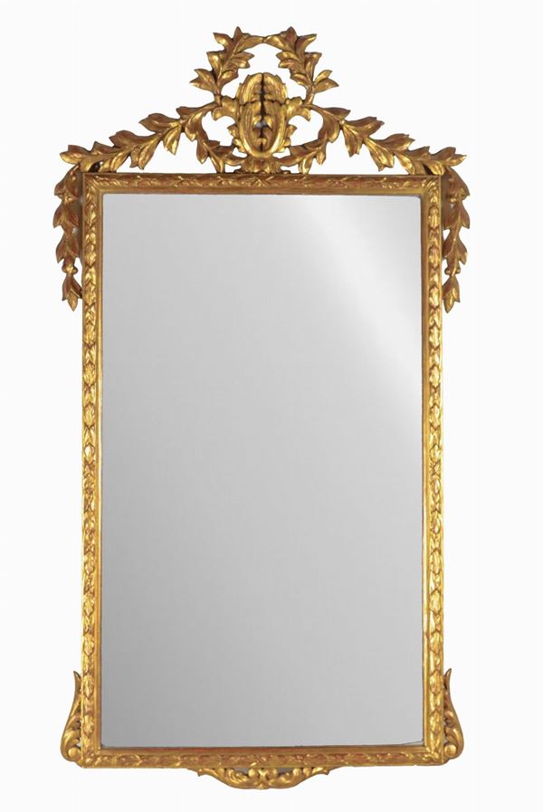 Mirror in gilded wood and carved with Louis XVI motifs