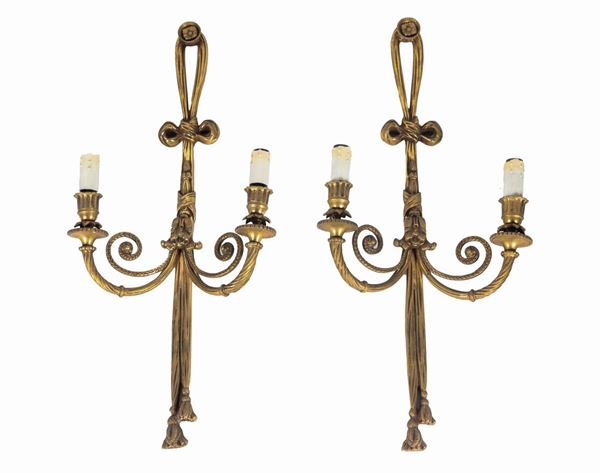 Pair of French sconces in gilt bronze, embossed and chiseled with Louis XVI bow motifs, 2 lights each