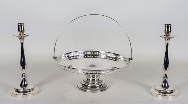 Lot in silvered and embossed metal of a round basket with perforated edge and a pair of candlesticks (3 pcs)