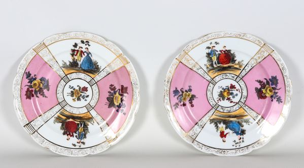 Pair of Vienna porcelain wall plates, with colorful decorations featuring gallant scenes and bunches of flowers