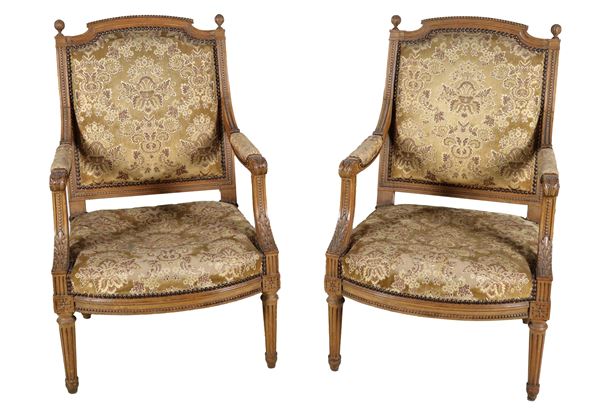 Pair of antique French Louis XVI armchairs in pickled wood, carved with beading motifs, acanthus leaves and pine cones, four fluted legs and flowered fabric cover