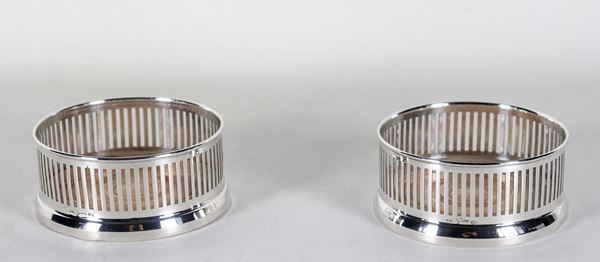 Pair of pierced silver bottle coasters with wooden base, marked Goretta