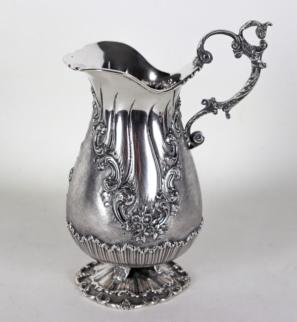 Ancient silver jug entirely chiselled and embossed with scrolls and floral garlands, gr. 640