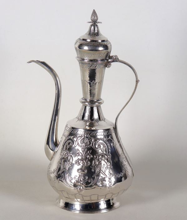 Antique large oriental silver coffee pot, richly chiseled and embossed with scrolls and floral garlands. Defect on the beak and some dents, gr. 1120