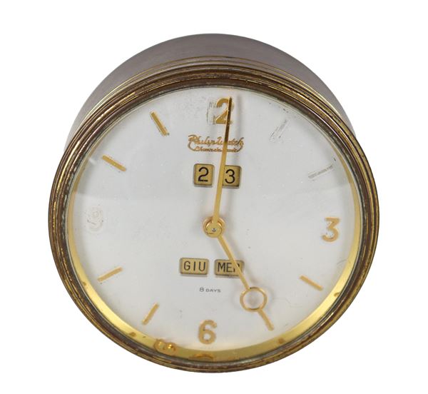 Philip Watch table alarm clock, 1950s-60s, in round-shaped golden metal. One numeral on the dial is detached, not working, and needs to be serviced