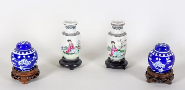 Lot of two pairs of small Chinese porcelain vases, different decorations, attached teak bases