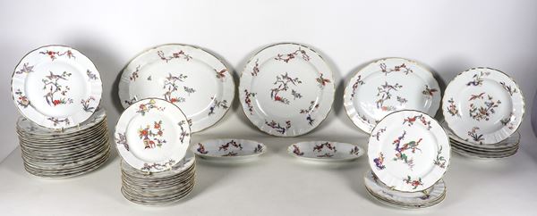 White Limoges-L porcelain dinner service. BERNARDAUD & C., with decorations painted in relief with chinoiserie motifs and edges in pure gold (45 pcs). Two plates have slight chipping on the edge