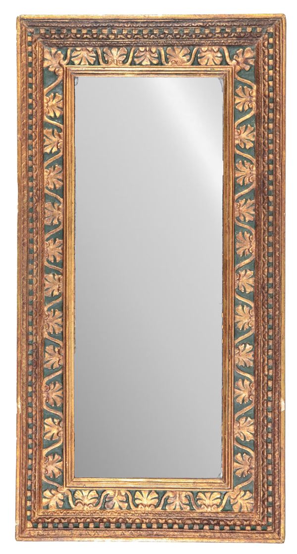 Ancient gilded and green lacquered wooden frame, with floral motif carvings, mirror inside