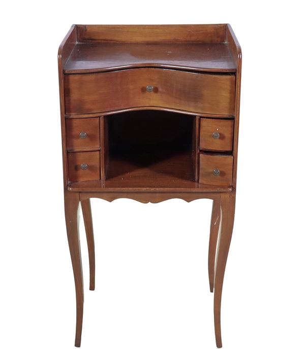 Shaped mahogany bedside table with central open compartment and five small drawers, four curved legs