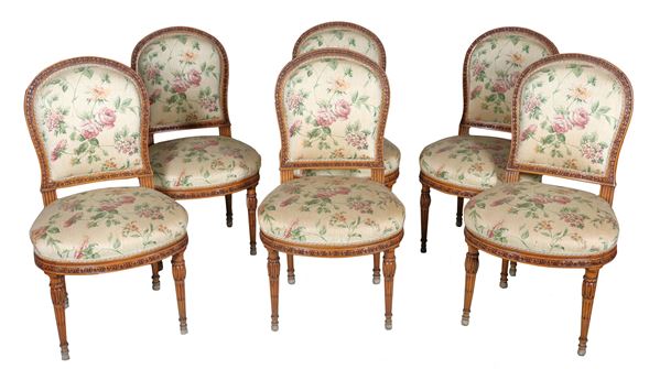 Lot of six French Louis XVI chairs in pickled wood, carved with neoclassical motifs with semi-oval backs, flowered fabric cover