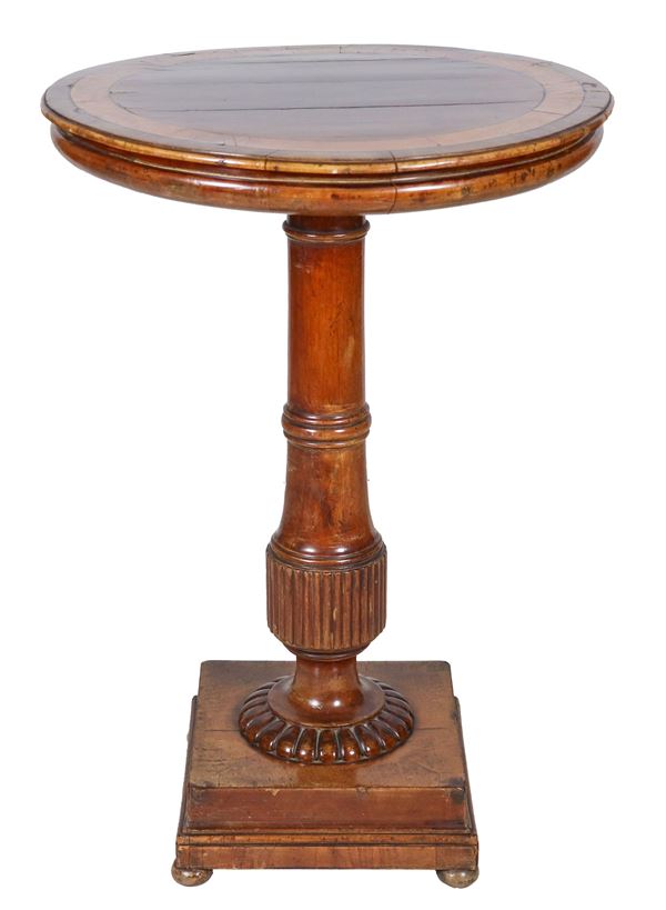 Round center table in walnut with inlaid top, supported by a turned column and pod resting on a square base