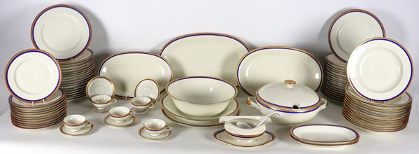 Bavaria Eschenbach white porcelain dinner set with blue and gold edge (76 pcs). A saucer and an oval serving plate have a defect on the edge
