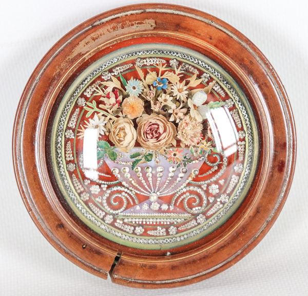 Ancient small round relic with amphora, bunch of flowers and beads, defective walnut frame