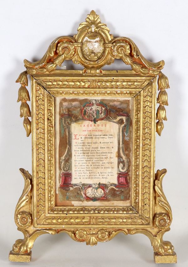 Ancient small Roman frame in gilded wood and carved with acanthus leaves, flowers and curls. Ancient Latin prayer inside, slight defects