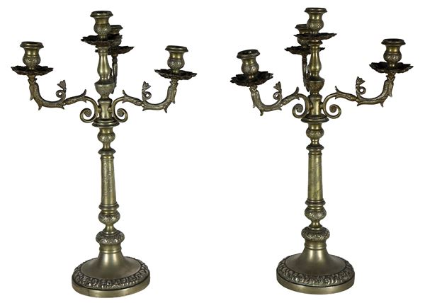 Pair of candelabras in silver metal, embossed and chiseled with Empire motifs, 4 flames each