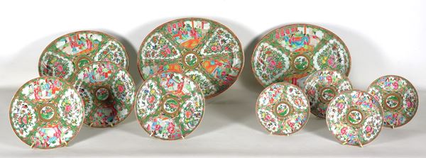 Antique lot of ten Chinese Canton porcelain wall plates, with polychrome enamel decorations in relief of scenes of oriental life, floral and bird garlands, different shapes and sizes. Slight chips