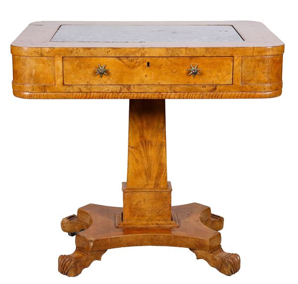 Antique French center table from the Directory period, in satin wood with marble top, three drawers, two small and one large and two folding shelves on the sides, column base resting on a shaped top, supported by four curved feet
