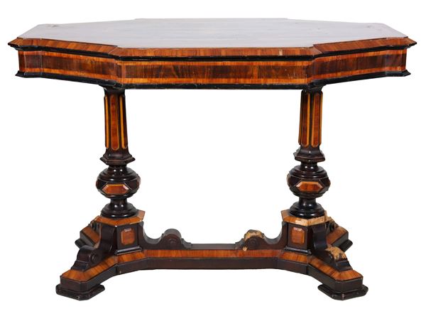 Antique Louis Philippe center table, octagonal shape in walnut, bois de rose and purple ebony, on the top an oval medallion with floral motif inlays, two turned column legs, joined by a shaped cross. Various defects on the legs