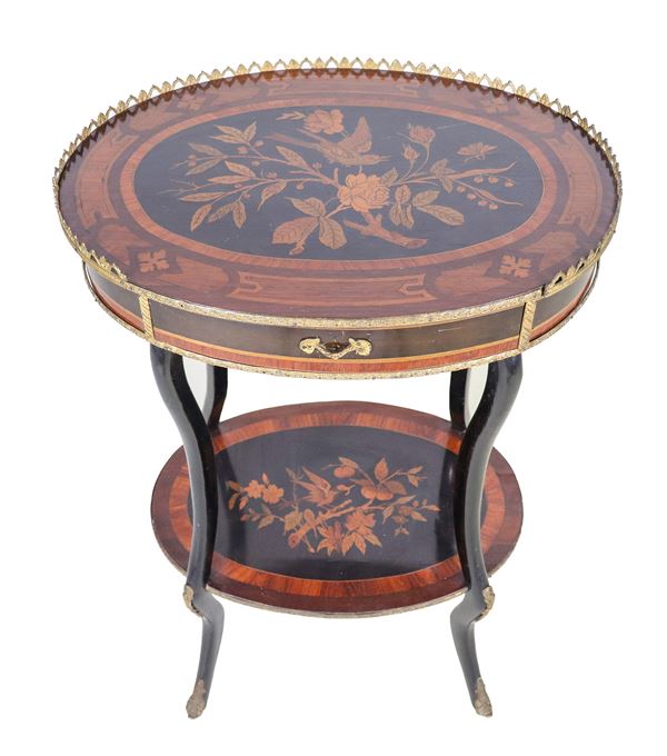 Antique French gueridon from the center in mahogany, purple ebony and bois de rose, with inlays with motifs of flowers, leaves and birds, gilded bronze trimmings, perforated railing on the top, a central drawer and four ebonized legs joined by a shelf below