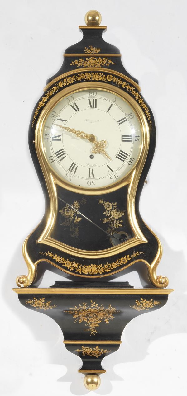 Cartel clock with shelf in black lacquered wood and golden decorations, signed Hausmann & C.- Roma, white enamel dial with Roman numerals, Zenith machine