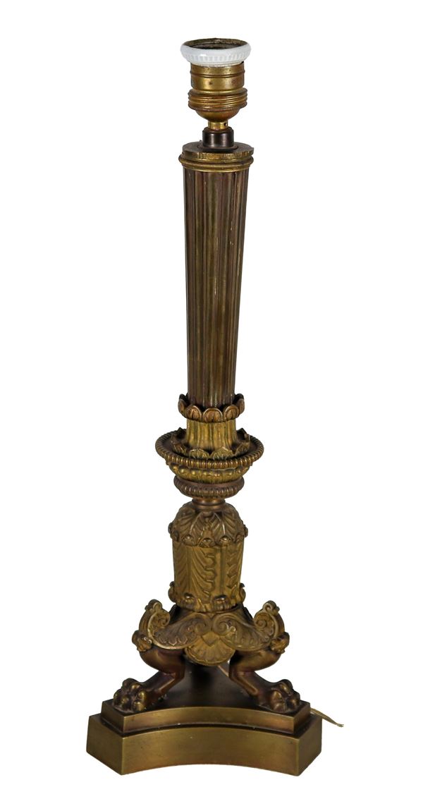 Antique French Empire era candlestick in chiseled and embossed bronze. Nineteenth century