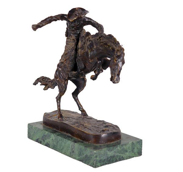 Frederic Remington - Signed. "Bronco Buster", bronze sculpture supported by a green marble base