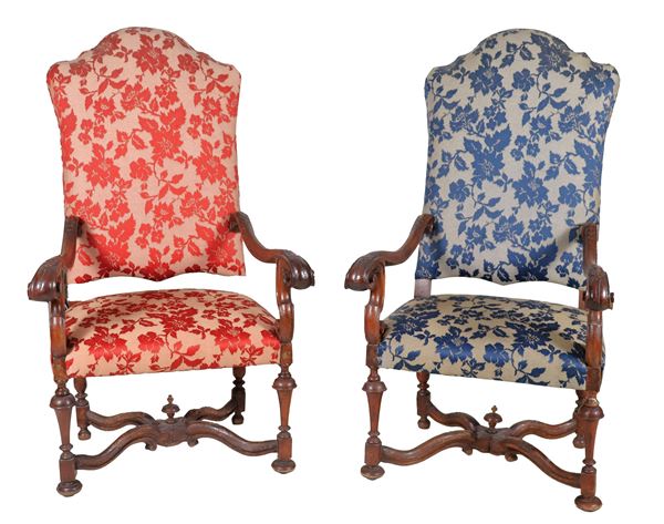 Pair of antique Louis XIV style Bolognese armchairs in walnut, with four curved armrests and four turned legs joined by a shaped cross. Defects on one leg and on the crosspieces