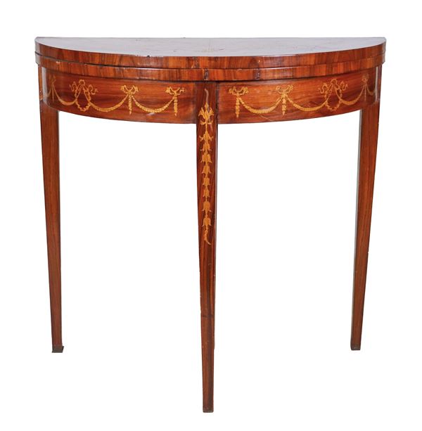 Semi-round game table in walnut and bois de rose, with inlays of floral scrolls, amphora and garlands. Folding top with green leather covering inside, four legs, one of which is extractable