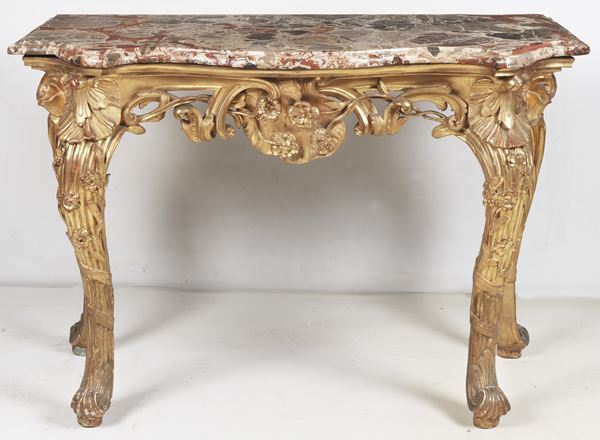 Ancient Transition console, in gilded wood and carved with scrolls, flowers, shell and cords, four curved legs and top in brecciated peach blossom marble