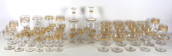 Lot of two bottles and fifty-four crystal glasses with pure gold decorations, various shapes, sizes and decorations (56 pieces). Early 20th century manufacturing