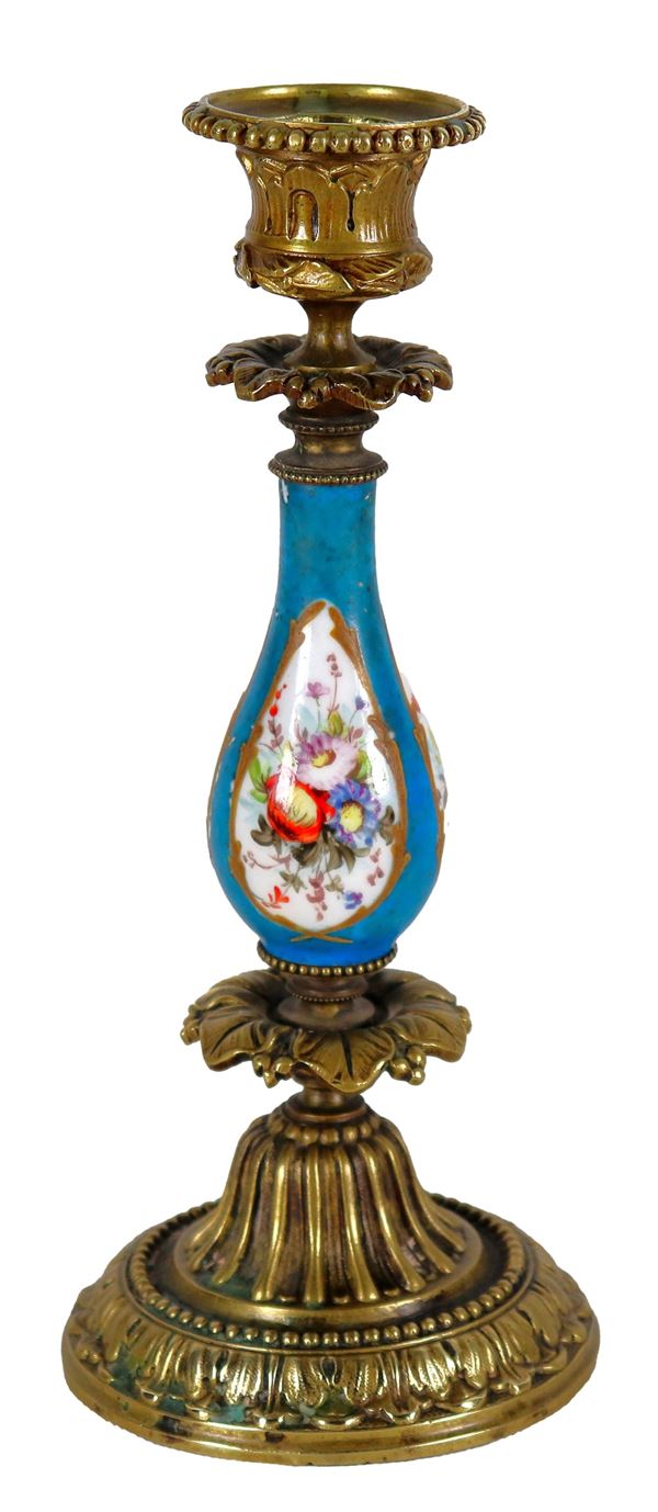 Antique Sèvres porcelain candlestick, with colorful decorations of bunches of flowers on a light blue background, base and bobeche in gilded and chiseled bronze