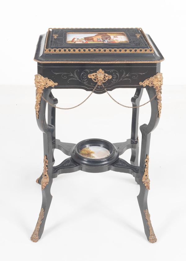 Antique French Napoleon III poudresse in black lacquered wood, with painted porcelain plaques depicting &quot;Peasant scenes&quot;, gilded bronze trimmings, embossed and chiselled, four curved legs joined by a shaped crosspiece