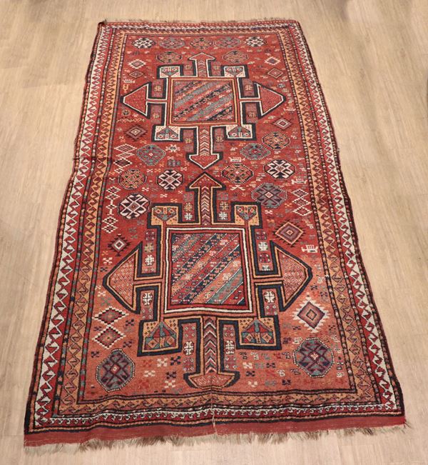 Persian Kurdi carpet with geometric design on red background