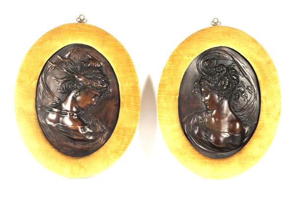 &quot;Faces of Vestal Virgins&quot;, pair of oval bronze plaques embossed in relief, in yellow ochre velvet frames