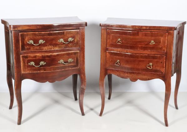 Pair of Louis XVI style bedside tables in walnut, with rosewood inlaid fillets, two drawers and four curved legs each. The bedside tables have differences in the handles and the height of the top