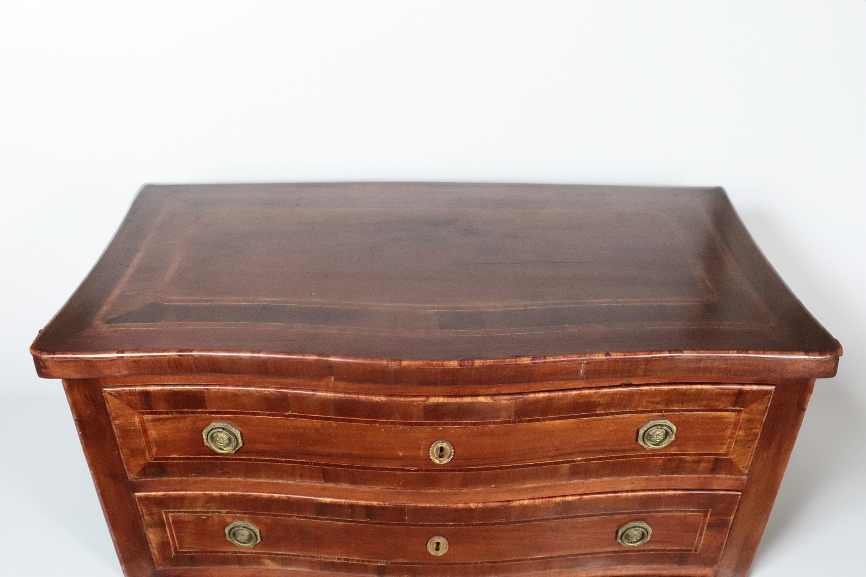 Cassettone romano in noce di linea Luigi XVI, con filettature intarsiate, tre tiretti, maniglie i...