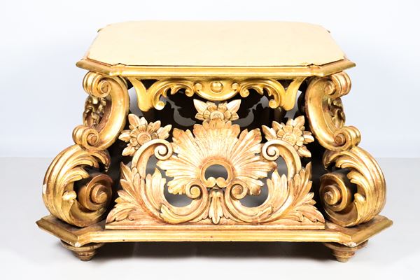 Large quadrangular base in gilded wood richly carved with Louis XIV motifs, ivory lacquered top