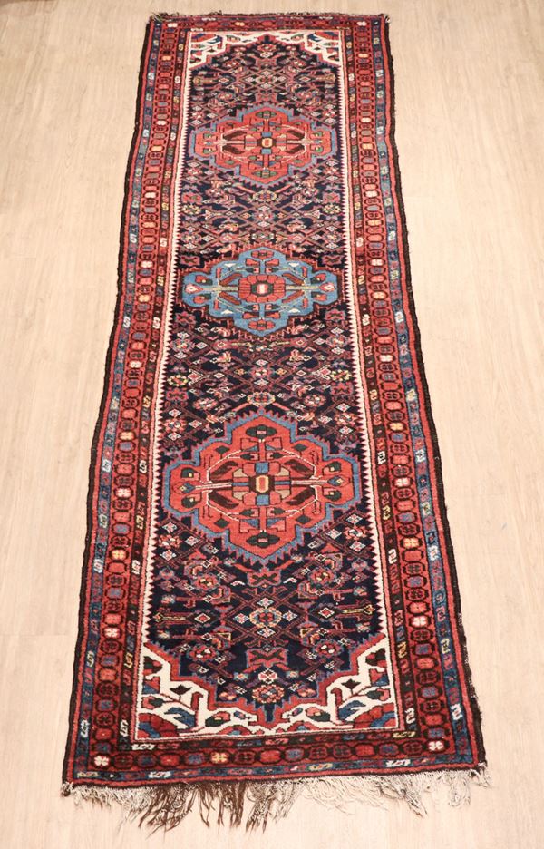 Persian Shirvan rug with geometric and floral designs on a blue, red and light blue background