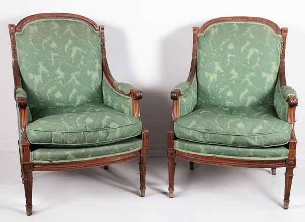 Pair of antique French Bergère armchairs in mahogany with Louis XVI motif carvings, green fabric covering