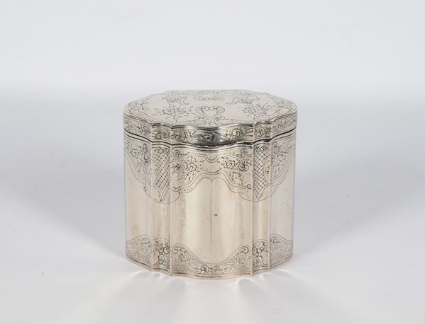 Antique silver tea box, oval shaped and faceted, chiseled and embossed with floral scrolls, 274 g