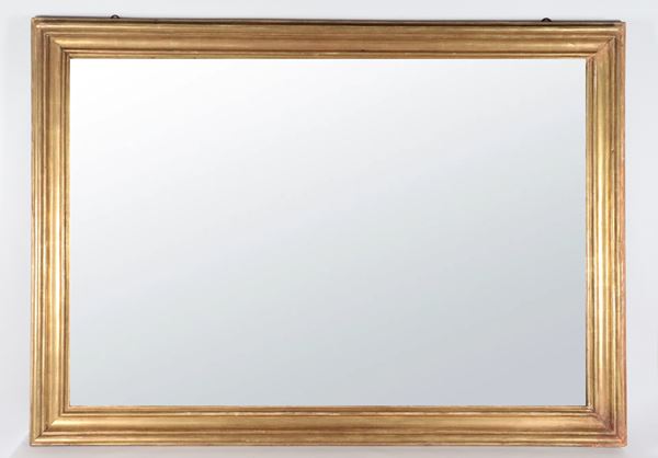 Antique gilded wooden frame with mirror inside