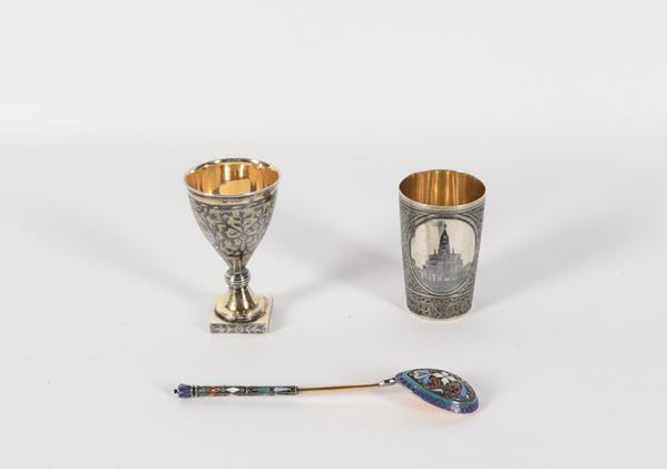 Antique Russian silver batch, nielloed and chiselled, of an egg cup, a small glass and a caviar spoon with polychrome enamel applications, vermeil interiors (3 pcs). Moscow stamps, Second Half of the 19th Century, gr. 170