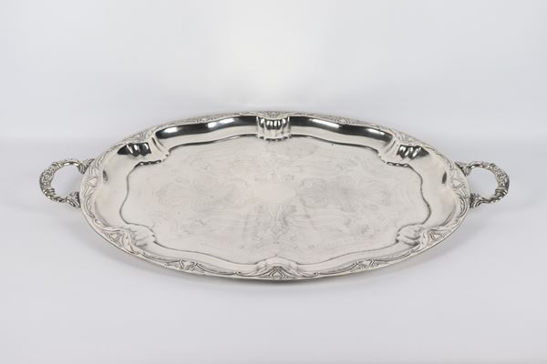 Large oval tray in embossed and chiseled silver metal with two handles 